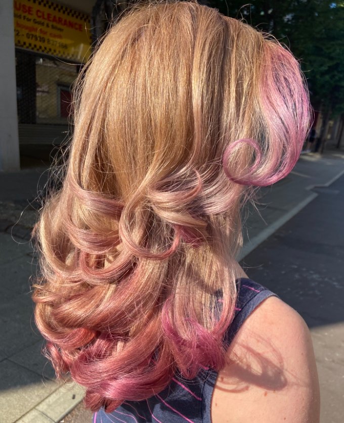 Photo showcasing a stunning Balayage and Ombre hairstyle from Hair Salon Romford, featuring seamlessly blended colors transitioning from dark roots to lighter ends, creating a natural, dimensional effect.