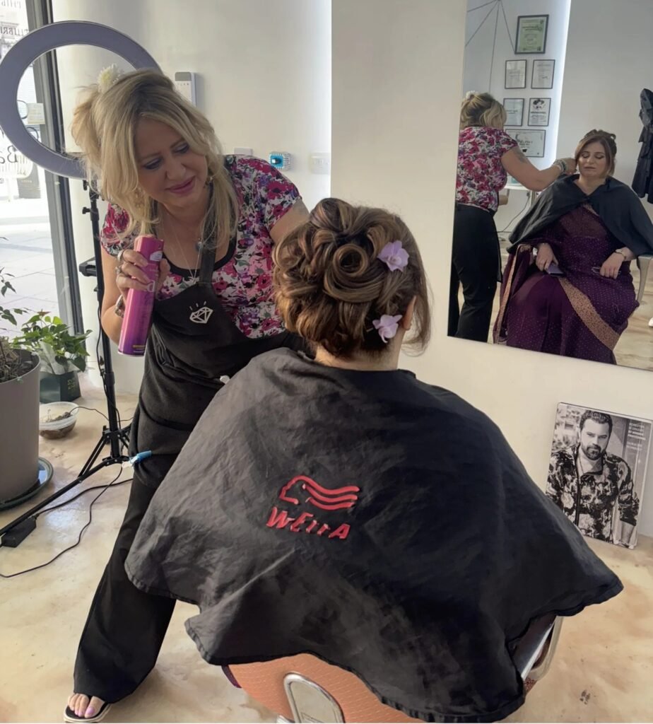 Lora finishing a client's updo at Loret Beauty, Romford.